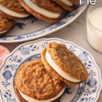 Pinterest graphic of a plate with two oatmeal cream pies with a glass of milk and platter in the background.
