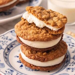 A stack of three oatmeal cream pies with the top one half eaten.