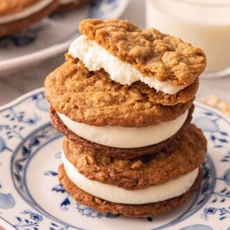A stack of three oatmeal cream pies with the top one half eaten.