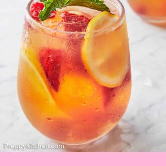 Pinterest graphic of a glass of rose sangria with fresh mint on top.