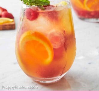 Pinterest graphic of a glass of rose sangria with fresh mint on top.