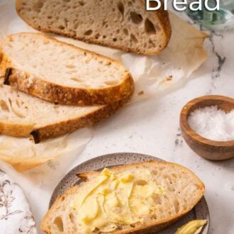 Pinterest graphic of a plate with a slice of sourdough bread with butter on it in front of sliced bread.