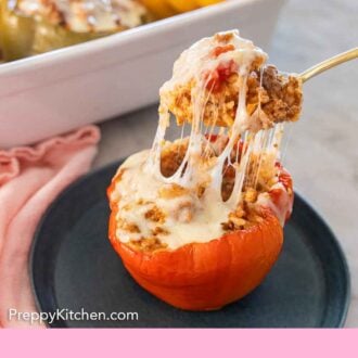 Pinterest graphic of a cheesy forkful of filling lifted from a stuffed pepper.