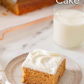 Pinterest graphic of a plate with a square piece of frosted applesauce cake with a glass of milk in the back.