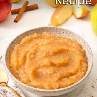 Pinterest graphic of a bowl of applesauce with apples and cinnamon in the background.