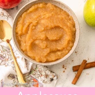 Pinterest graphic of an overhead view of a bowl of applesauce with whole and cut apples and cinnamon sticks scattered around.