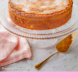 Pinterest graphic of a cake stand with an olive oil cake with a spatula in front.