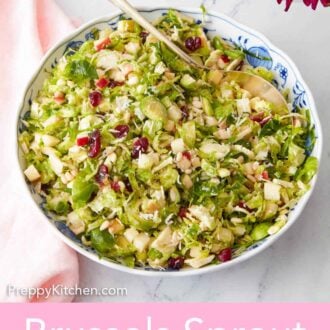Pinterest graphic of a large bowl of Brussels sprout salad with a spoon tucked into the bowl.