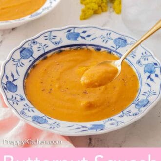 Pinterest graphic of a spoonful of butternut squash soup lifted from the bowl of soup.