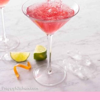 Pinterest graphic of a Cosmopolitan strained into a cocktail glass.