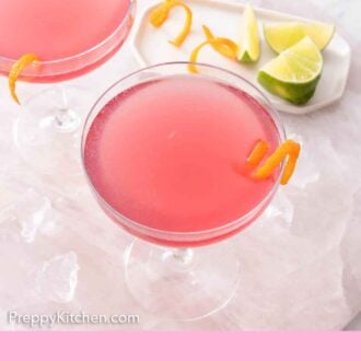 Pinterest graphic of an overhead view of two glasses of Cosmopolitans with citrus on a plate in the back.