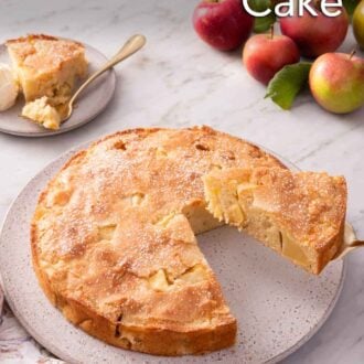 Pinterest graphic of a slice of French apple cake lifted from the cake on a round plate. A plated slice in the background.