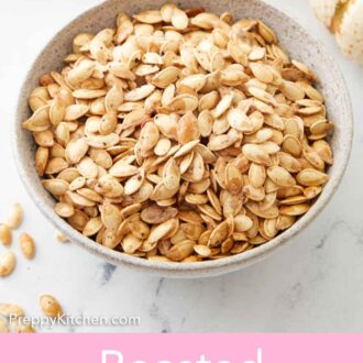 Pinterest graphic of a bowl of roasted pumpkin seeds with some scattered on the counter.