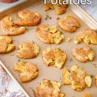 Pinterest graphic of a sheet pan with smashed potatoes. Some freshly chopped dill and pepper garnished on top and on the side.