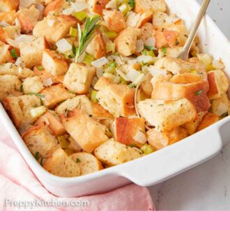Pinterest graphic of a spoon inserted into a white baking dish of stuffing.