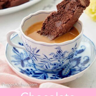 Pinterest graphic of a mug of coffee with a chocolate biscotti dipped inside.