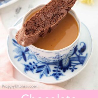 Pinterest graphic of a chocolate biscotti resting on top of a mug of coffee.