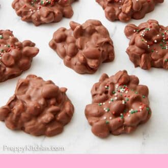 Pinterest graphic of seven pieces of crockpot candy on a single layer with a couple with sprinkles on them.