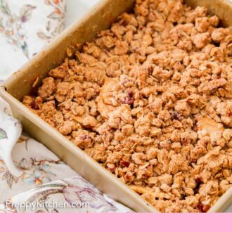 Pinterest graphic of a square baking of pear crisp with a floral linen beside it.