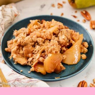 Pinterest graphic of a plate of pear crisp with a fresh pair in the background.