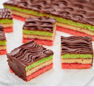 Pinterest graphic of multiple pieces of rainbow cookies cut off the main piece in the back.