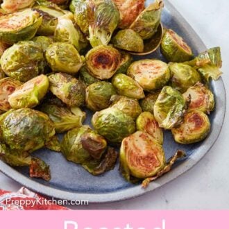 Pinterest graphic of a blue platter of roasted Brussels sprouts.