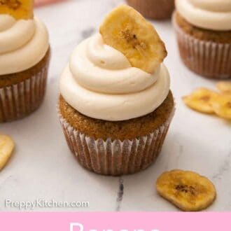 Pinterest graphic of a banana cupcakes with a banana chip inserted in the frosting with additional cupcakes in the back.