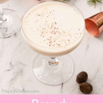 Pinterest graphic of a glass of Brandy Alexander with some festive garnish and nutmeg on the counter.