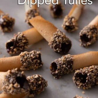 Pinterest graphic of multiple chocolate dipped tuiles scattered on a counter.