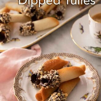 Pinterest graphic of a small plate with four chocolate dipped tuiles with more in a platter in the back.