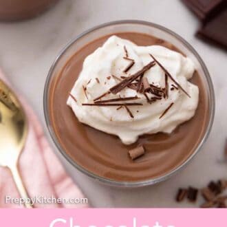 Pinterest graphic of an overhead view of a glass of chocolate pudding with shaved chocolate on top.