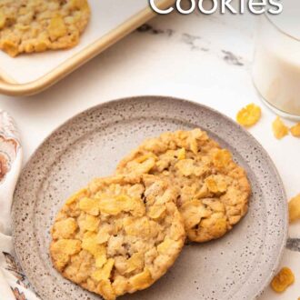 Pinterest graphic of a plate with two cornflake cookies with a sheet pan with more in the back.
