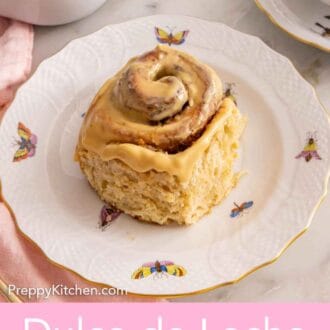 Pinterest graphic of a dulce de leche cinnamon roll on a plate with a cream cheese glaze over top.