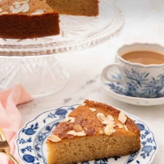 Pinterest graphic of a plate with a slice of honey cake with a mug of coffee and the rest of the cake in the background.