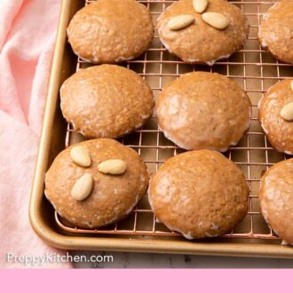 Pinterest graphic of multiple Lebkuchen cookies on a wire rack over a sheet pan.