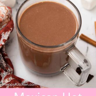 Pinterest graphic of a glass mug of Mexican hot chocolate.