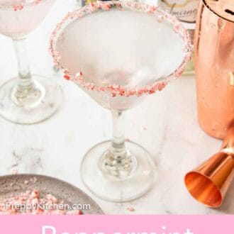 Pinterest graphic of a glass of peppermint martini with a second drink, bottles of alcohol, and shaker in the background.