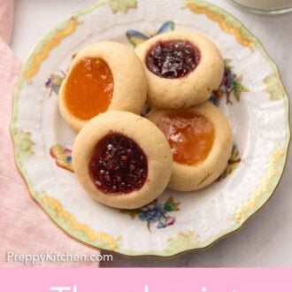 Pinterest graphic of a small plate with four thumbprint cookies with two different jam fillings.