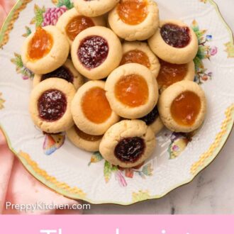Pinterest graphic of an overhead view of a plate of thumbprint cookies.