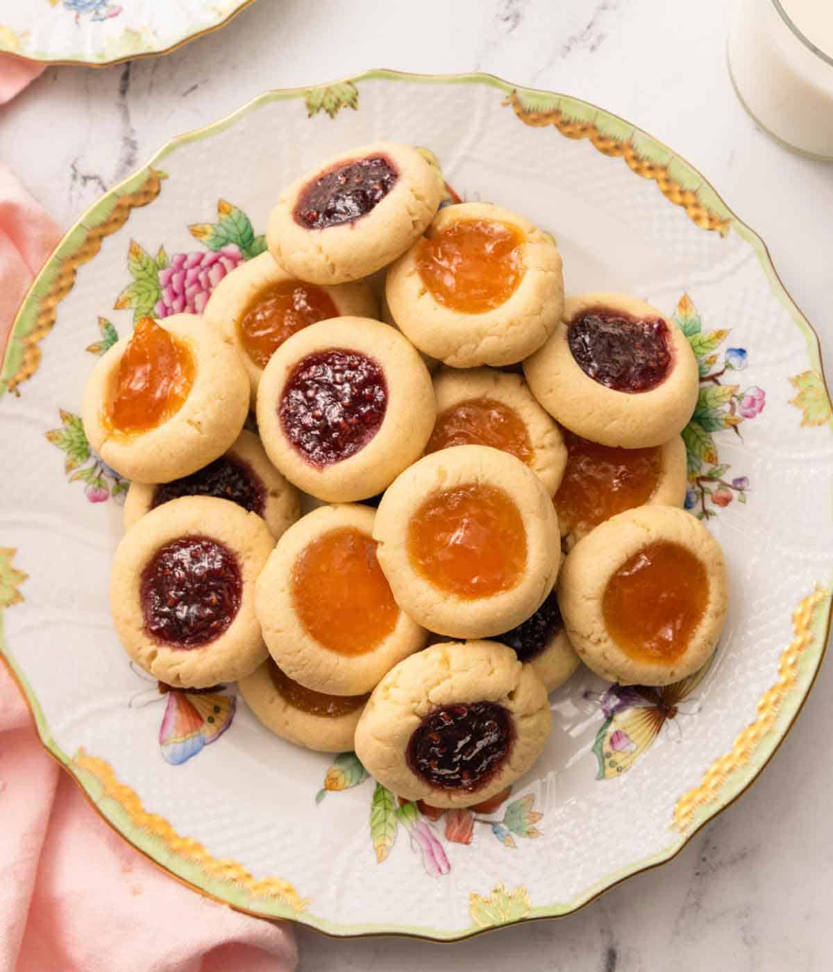 Overhead view of a plate of thumbprint cookies.