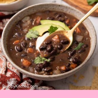 Pinterest graphic of a bowl of black bean soup with a spoonful lifted out.