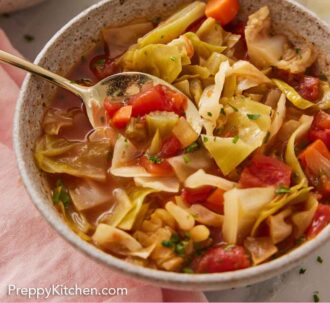 Pinterest graphic of a bowl of cabbage soup with a spoon inside.
