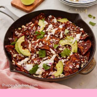 Pinterest graphic of a cast iron skillet of chilaquiles with cilantro, creama, and avocado on top with plates, forks, and limes in the background.