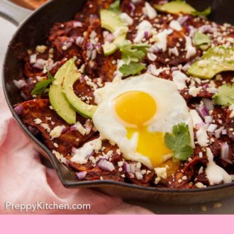 Pinterest graphic of a cast iron skillet of chilaquiles with a fried egg, sliced avocado, and cilantro on top.