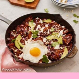 Pinterest graphic of a plate of chilaquiles with a fried egg, cotija cheese, cilantro, and sliced avocado on top.
