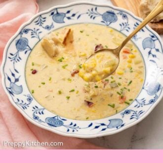 Pinterest graphic of a bowl of corn chowder with a spoonful lifted up.
