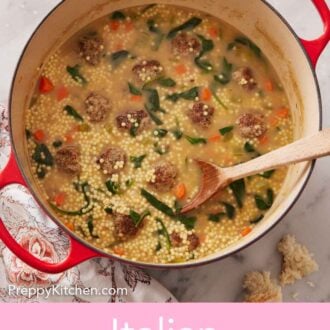 Pinterest graphic of a large pot of Italian wedding soup with a wooden spoon inside.