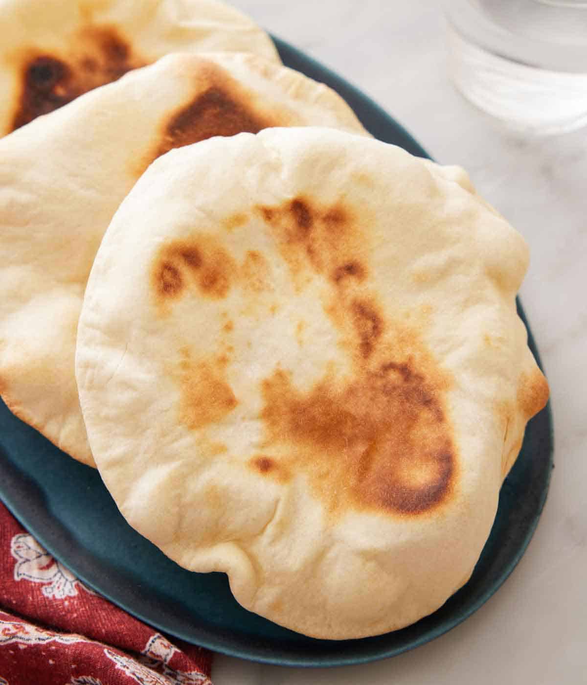 Close view of pita bread on an oval platter.
