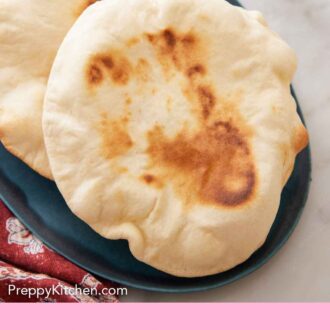 Pinterest graphic of a close view of pita breads on a platter.