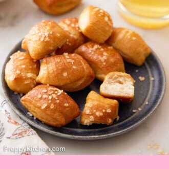 Pinterest graphic of a plate of pretzel bites with a drink in the background and some pretzel bites scattered around.